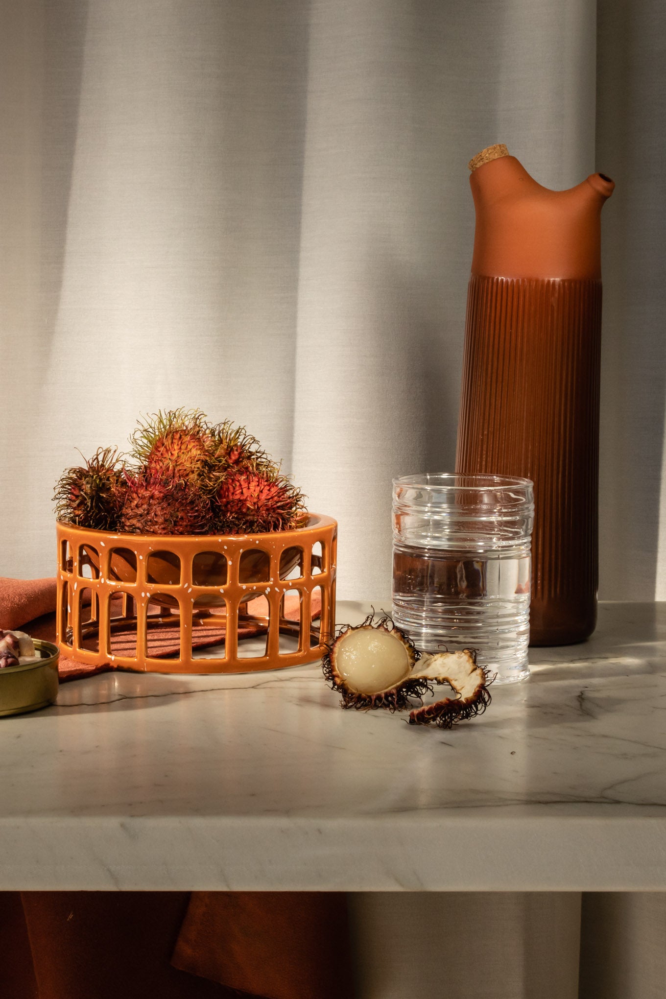 Terracotta Junto Carafe with fruits and water on the table