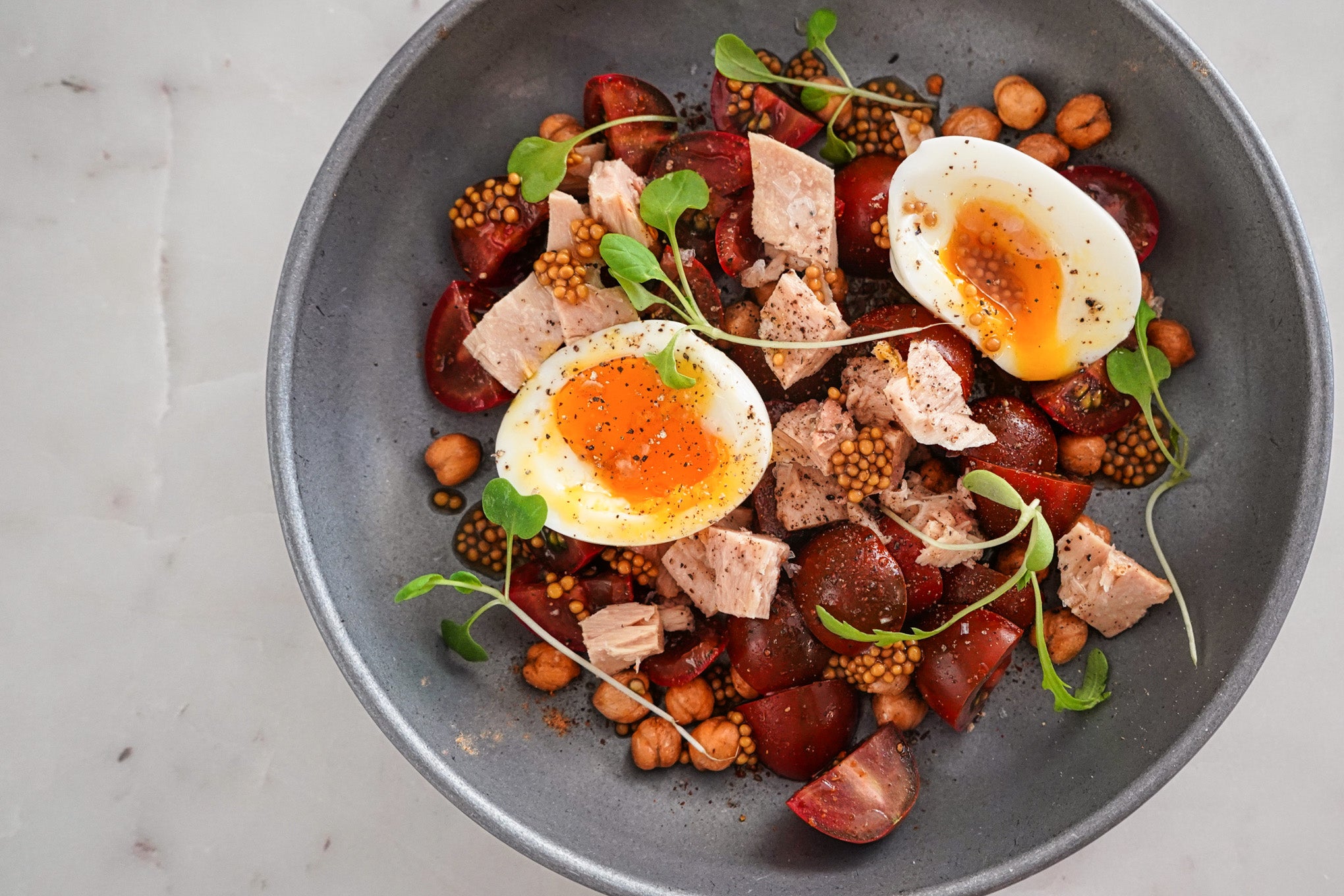 tuna and tomato salad with jammy eggs, chickpeas and mustard seeds